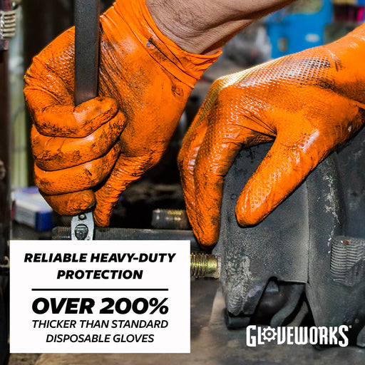 Close-up of a person wearing bright orange Gloeworx heavy-duty gloves while working on a mechanical part. A white text box at the bottom left reads 'RELIABLE HEAVY-DUTY PROTECTION OVER 200% THICKER THAN STANDARD DISPOSABLE GLOVES'.